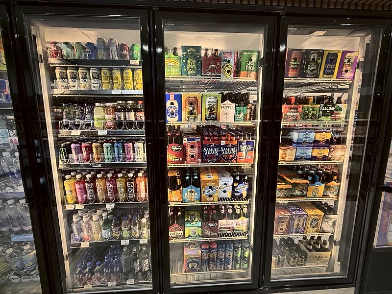 Glass-door coolers stocked with cold beer, seltzers and drinks