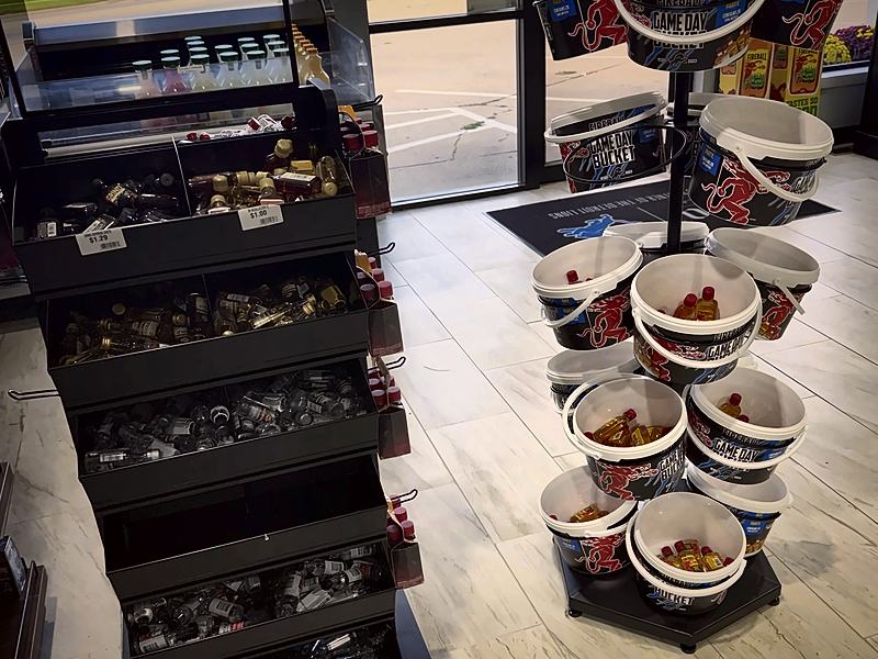 Bins of mini bottles and a stand of buckets just inside the front door