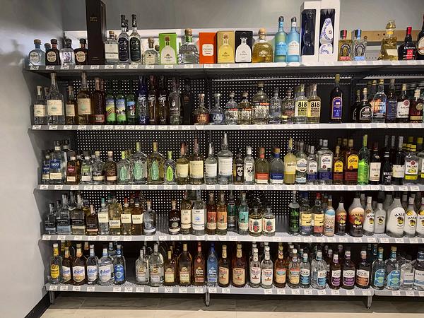 Wall of spirits shelving with a wide mix of bottles