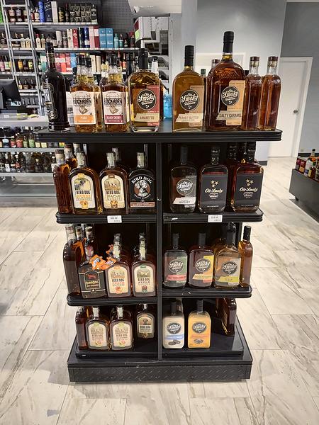 Island display of whiskey, with the rest of the store behind it