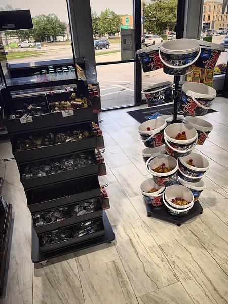 Bins of mini bottles and a rack of game-day buckets just inside the front doors