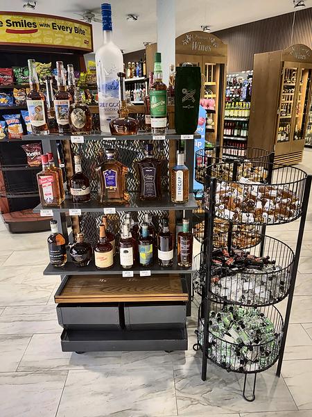 Featured bottles and baskets of minis, with wooden wine cabinets behind
