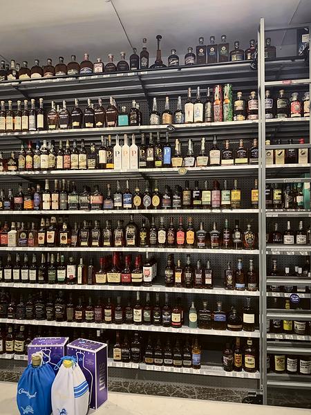 Tall wall of whiskey with a rolling library ladder