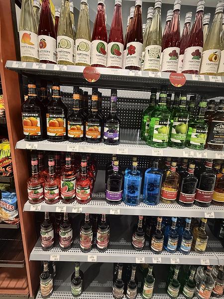 Shelves of flavored spirits and liqueurs in bright colors
