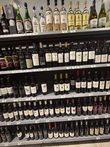 Wine shelves of reds with whites and sparkling on the top row