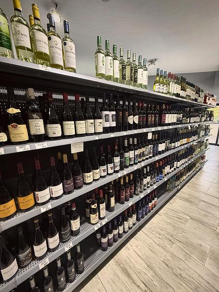 Long wine aisle stocked with reds and whites