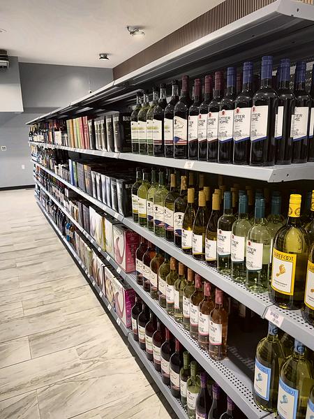 Wine aisle with bottled wines and boxed wines down the shelves