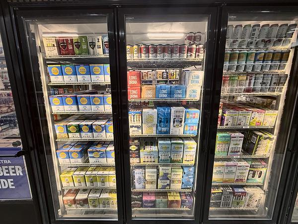 Cooler of cold beer and seltzer multi-packs