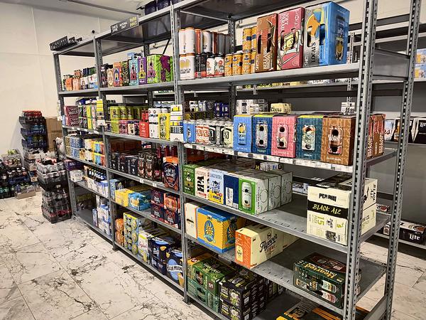 Beer section shelving stocked with craft and import packs